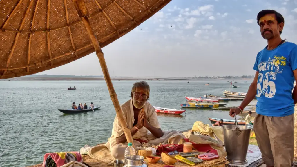 A very old pandit welcoming a visitor in Varanasi Ghat with joined hands